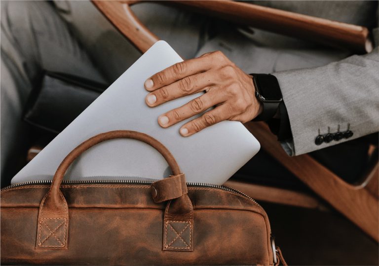 laptop placed into a leather bag
